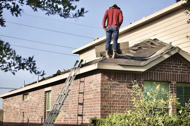 Professional roofer working on a residential roof in Orovada